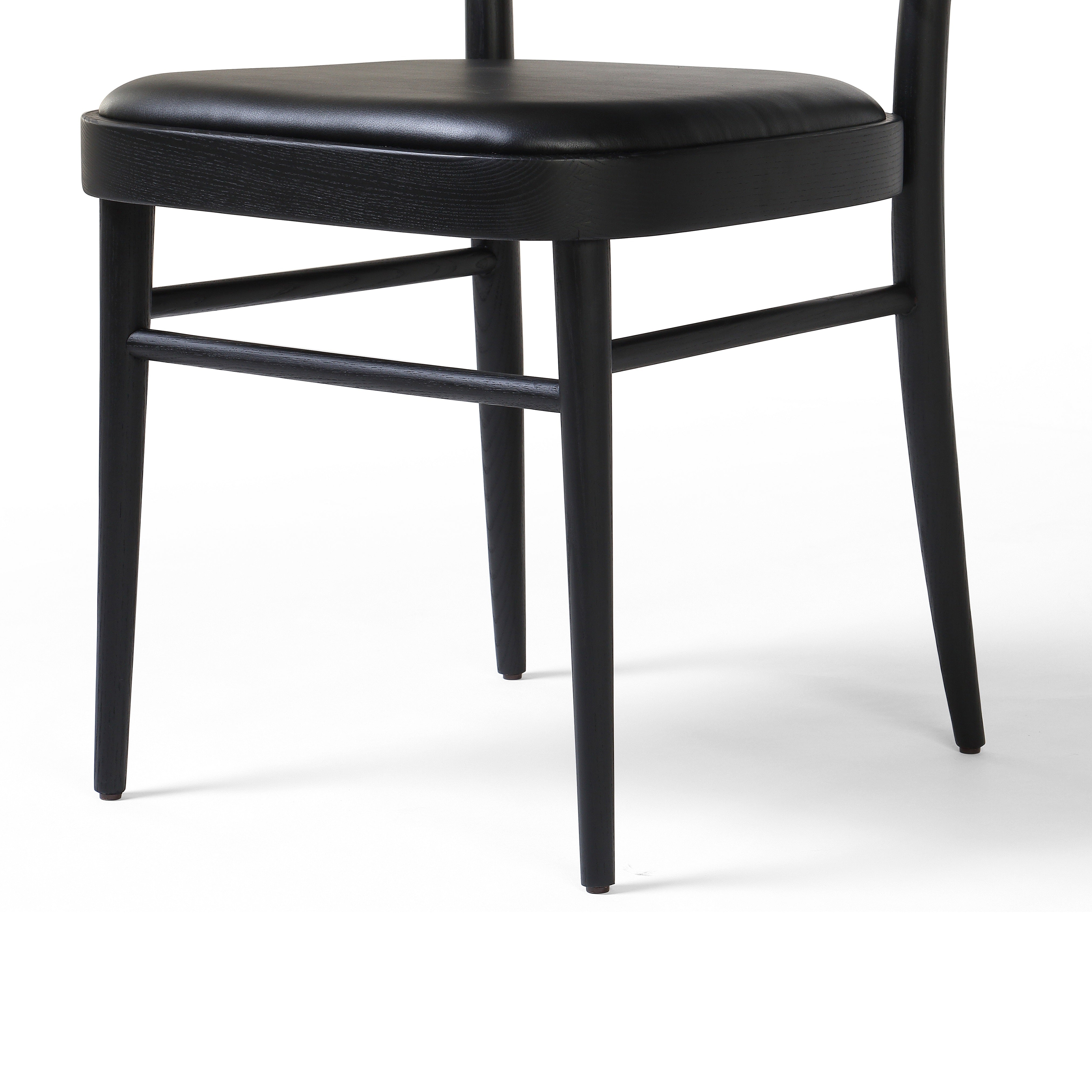 Inspired by the Thonet chair popularized in the mid-century, the Court Black Ash Dining Chair forms a simple but-shapely frame for black seating and a natural cane back. Amethyst Home provides interior design services, furniture, rugs, and lighting in the Seattle metro area.