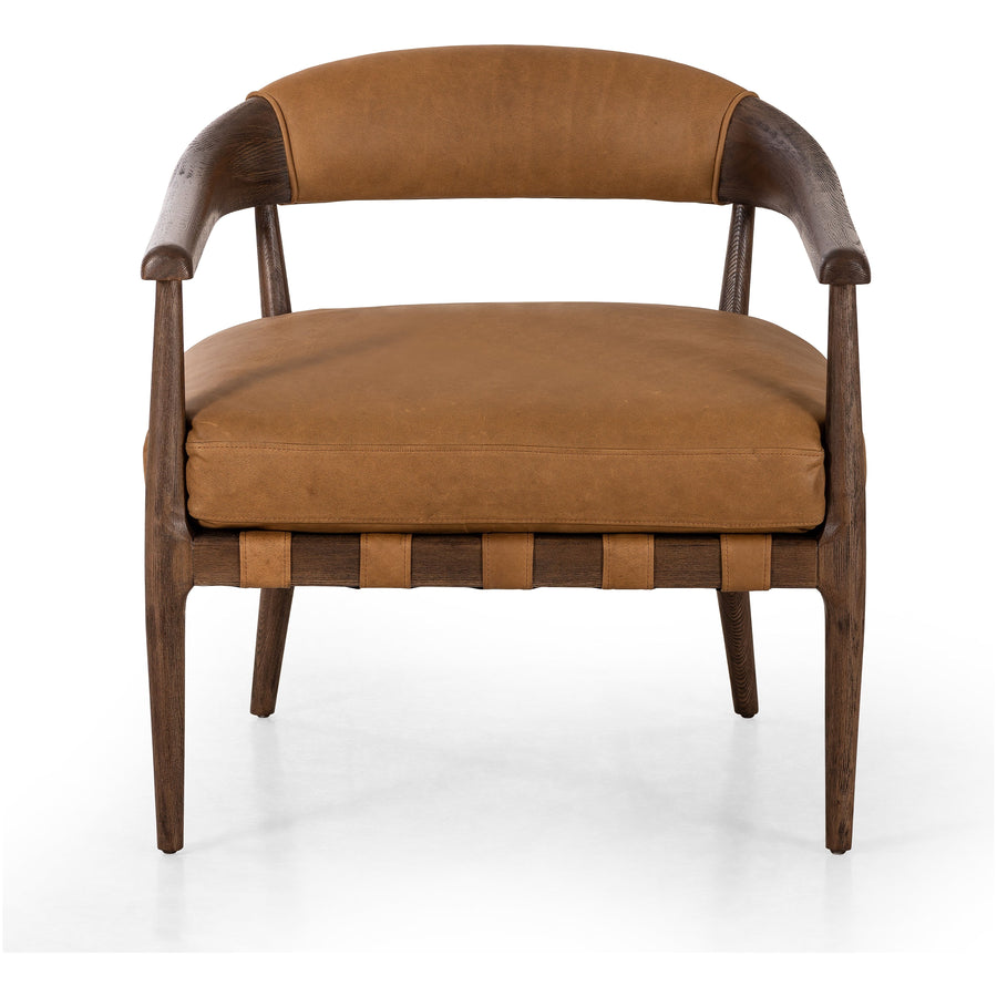 Safari styling is brought to modern speed on this vintage-inspired chair. Its solid wood frame features a webbed seating structure that brings a sink-in feel to the entire piece. The upholstered back, strap details and loose cushion are finished in carbon neutral, vegetable-tanned leather processed using naturally fallen eucalyptus leaves in Uruguay. Amethyst Home provides interior design, new construction, custom furniture, and area rugs in the Calabasas metro area.