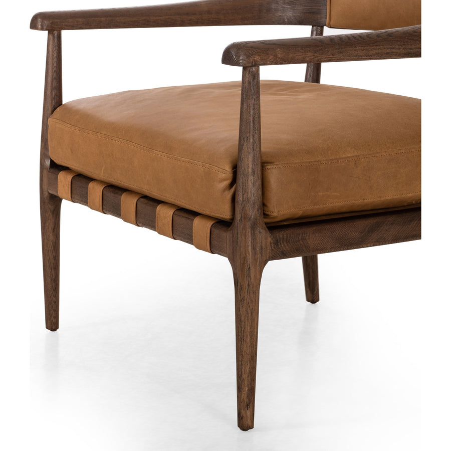 Safari styling is brought to modern speed on this vintage-inspired chair. Its solid wood frame features a webbed seating structure that brings a sink-in feel to the entire piece. The upholstered back, strap details and loose cushion are finished in carbon neutral, vegetable-tanned leather processed using naturally fallen eucalyptus leaves in Uruguay. Amethyst Home provides interior design, new construction, custom furniture, and area rugs in the Monterey metro area.