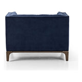 This low, tailored midcentury silhouette is upholstered in a velvety navy fabric, with dramatic blind tufting for texture.Collection: Kensingto Amethyst Home provides interior design, new home construction design consulting, vintage area rugs, and lighting in the Kansas City metro area.