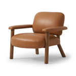 Sleek and inviting, this wood-meets-leather arm chair is timeless in any context. Large cylindrical legs support the upholstered back and seat, which are covered in camel-colored top-grain leather. Spring suspension adds comfort and durability to the seat cushion.Collection: Carnegi Amethyst Home provides interior design, new home construction design consulting, vintage area rugs, and lighting in the Calabasas metro area.