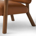 Sleek and inviting, this wood-meets-leather arm chair is timeless in any context. Large cylindrical legs support the upholstered back and seat, which are covered in camel-colored top-grain leather. Spring suspension adds comfort and durability to the seat cushion.Collection: Carnegi Amethyst Home provides interior design, new home construction design consulting, vintage area rugs, and lighting in the Monterey metro area.