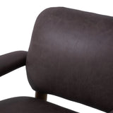 Sleek and inviting, this wood-meets-leather arm chair is timeless in any context. Large cylindrical legs support the upholstered back and seat, which are covered in bark-colored top-grain leather. Spring suspension adds comfort and durability to the seat cushion.Collection: Carnegi Amethyst Home provides interior design, new home construction design consulting, vintage area rugs, and lighting in the Washington metro area.