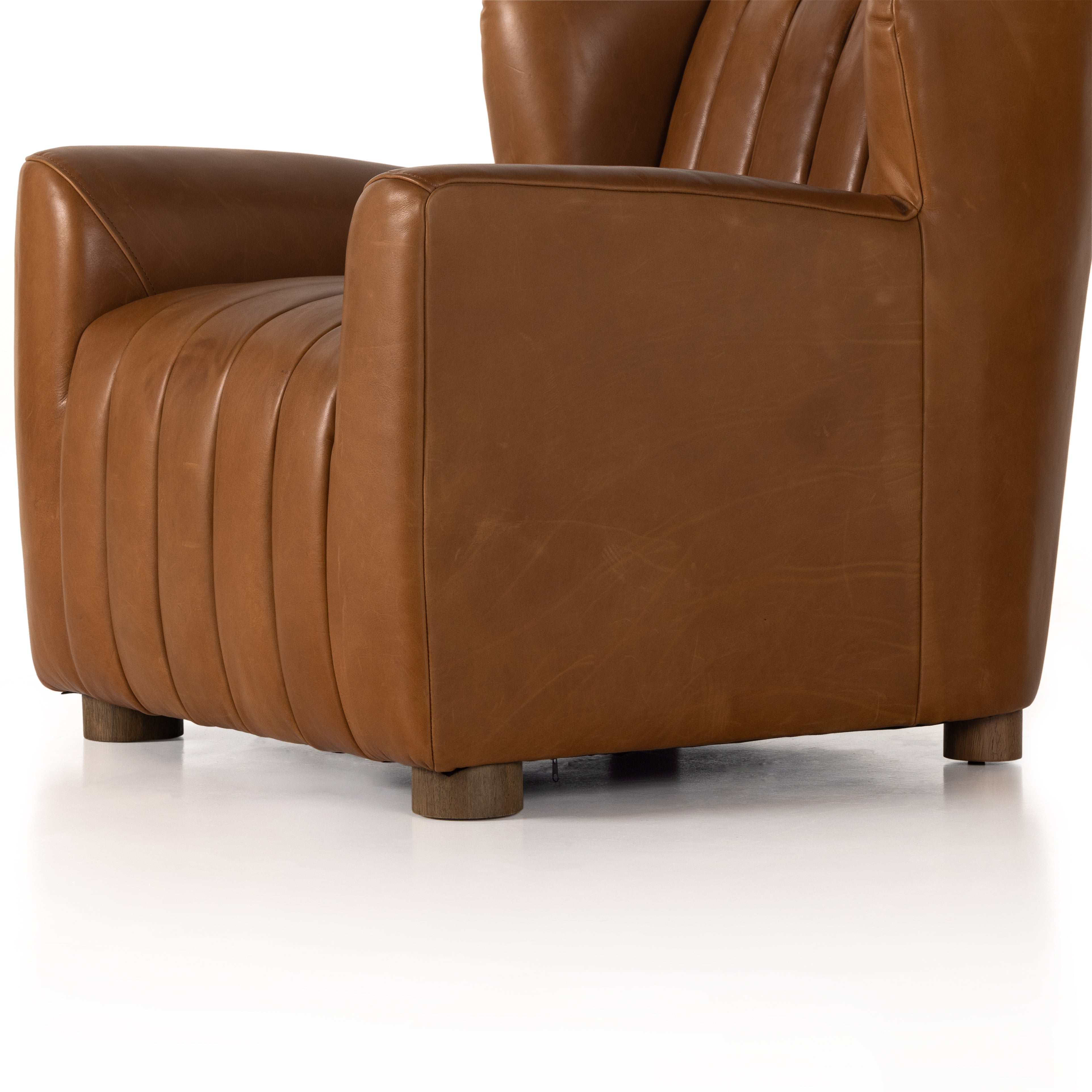 The classic wing-back club chair adopts heavy channeling for an even-comfier sit. Tobacco top-grain leather brings this retro lounge-inspired chair up to modern speed. Amethyst Home provides interior design, new construction, custom furniture, and area rugs in the Washington metro area.