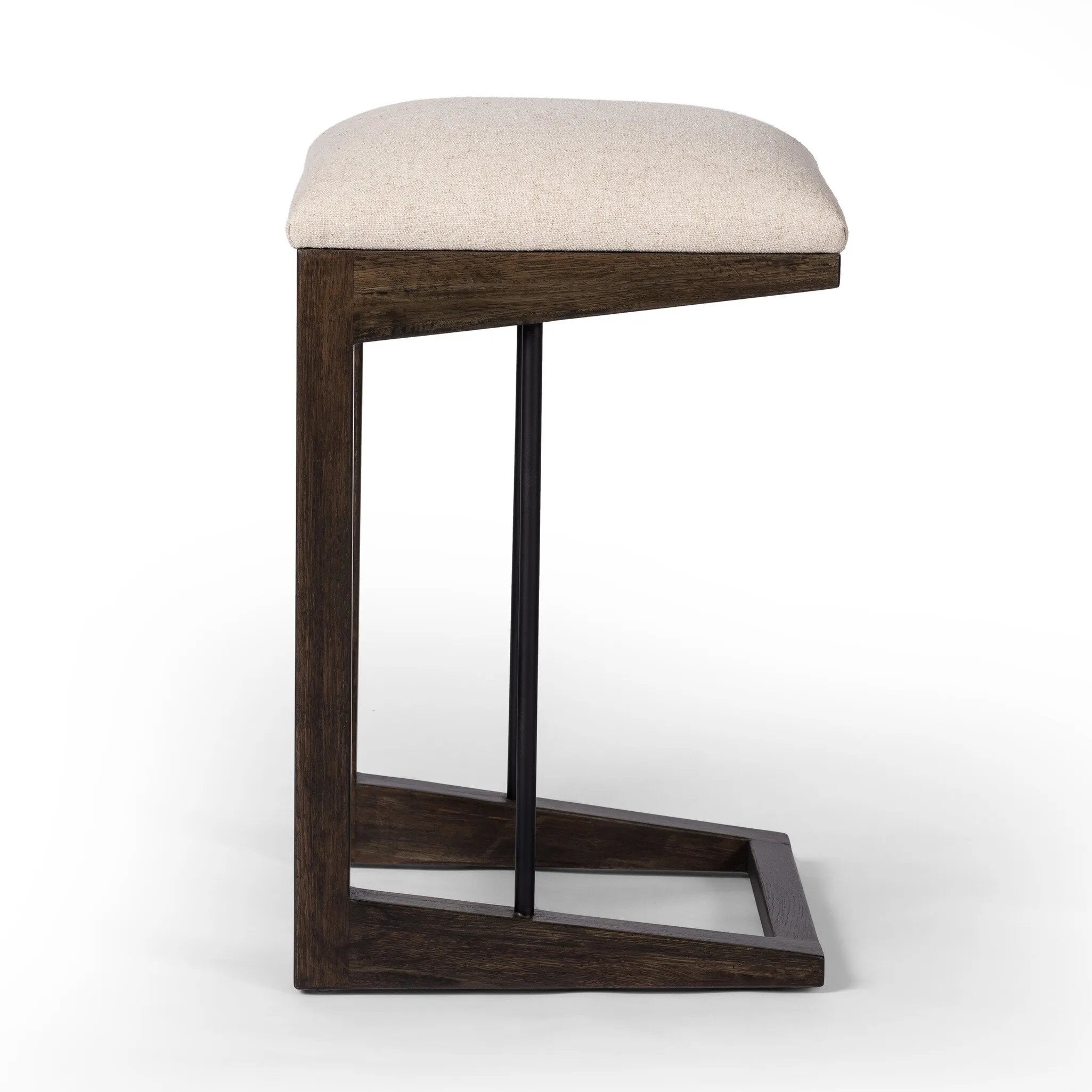 Featuring Finn Sienna Brown Oak Counter Stool by Four Hands at Amethyst Home. A stunner from every angle, this architecturally inspired stool features an angular base crafted from solid oak with two iron rods for added support and visual interest. Seat is upholstered in a linen/cotton/poly blend performance fabric with subtle texture throughout. Performance. Amethyst Home provides interior design, new home construction design consulting, vintage area rugs, and lighting in the Park City metro area.