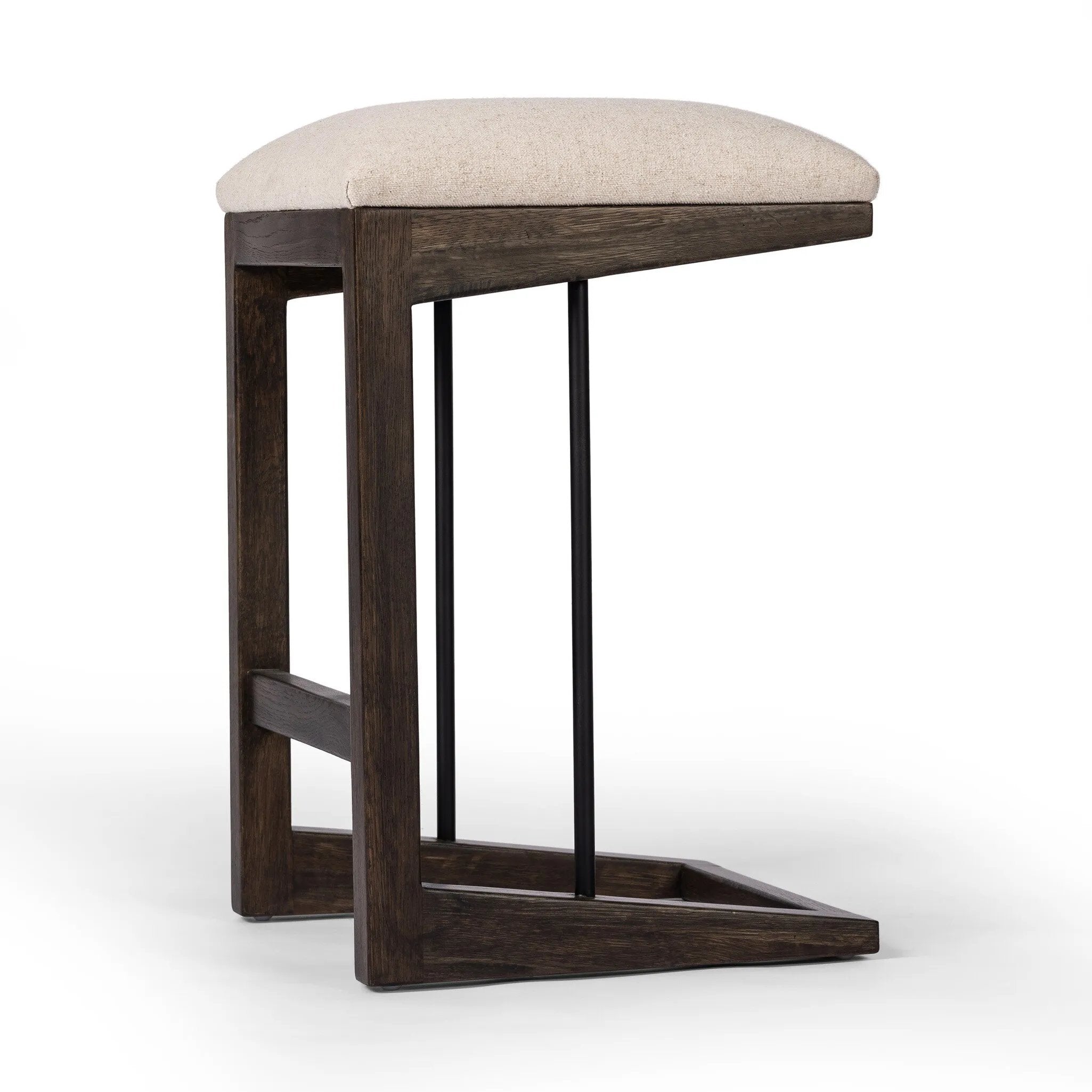 A stunner from every angle, this architecturally inspired stool features an angular base crafted from solid oak with two iron rods for added support and visual interest. Seat is upholstered in a linen/cotton/poly blend performance fabric with subtle texture throughout. Amethyst Home provides interior design, new home construction design consulting, vintage area rugs, and lighting in the Portland metro area.