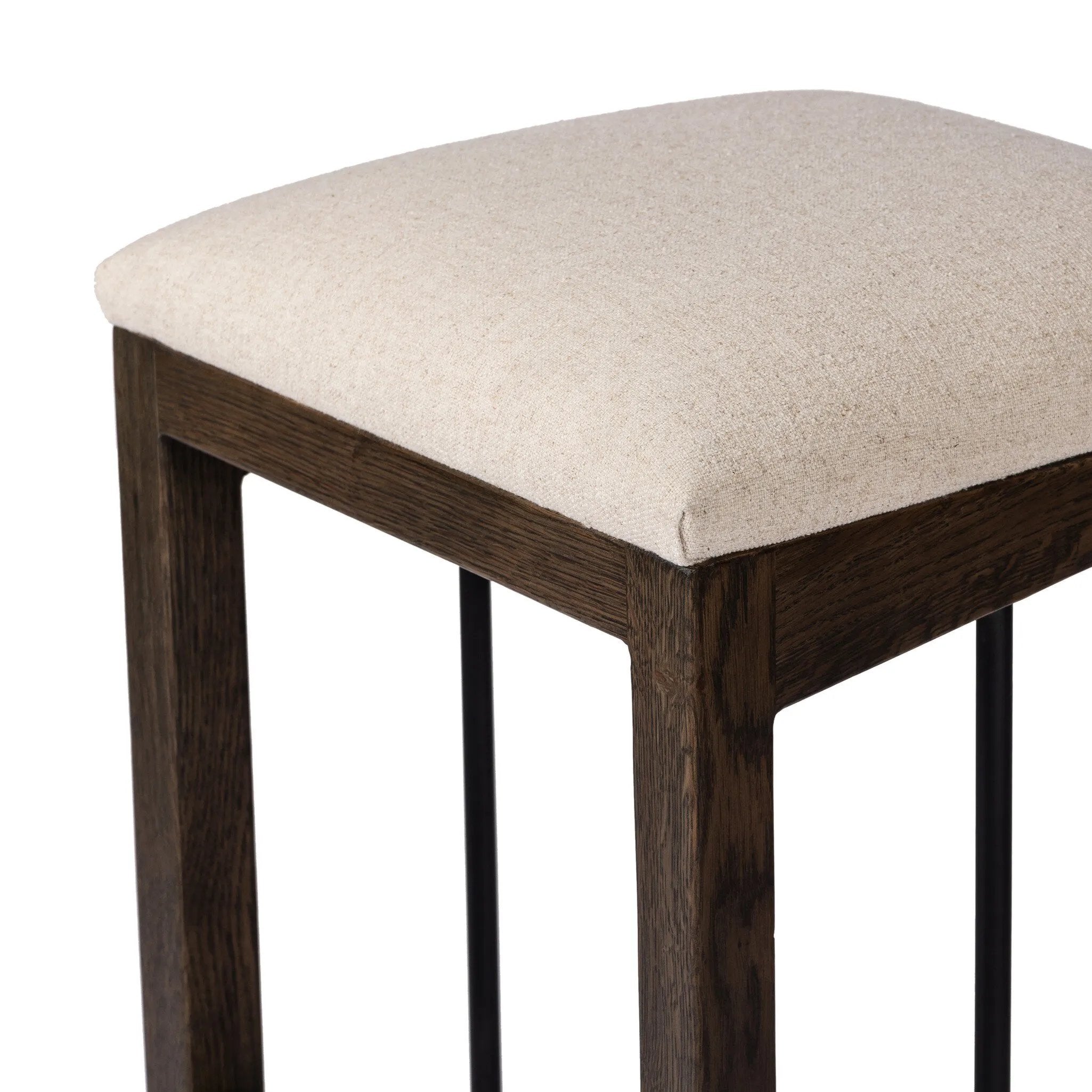 A stunner from every angle, this architecturally inspired stool features an angular base crafted from solid oak with two iron rods for added support and visual interest. Seat is upholstered in a linen/cotton/poly blend performance fabric with subtle texture throughout. Amethyst Home provides interior design, new home construction design consulting, vintage area rugs, and lighting in the San Diego metro area.