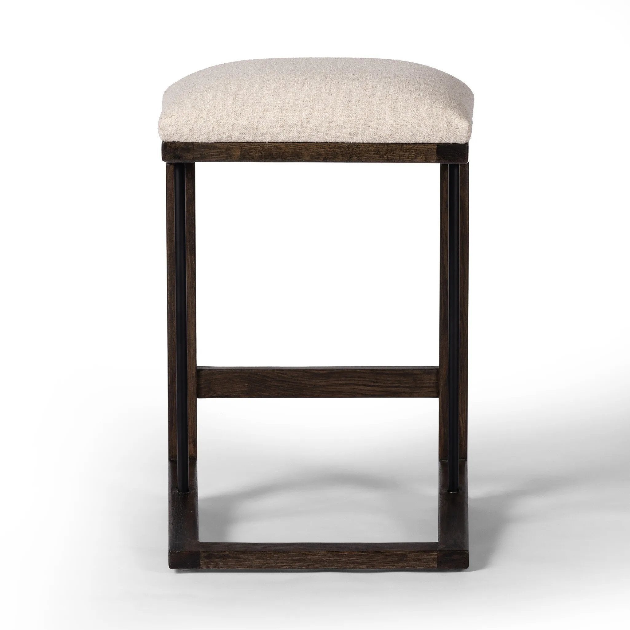 Featuring Finn Sienna Brown Oak Counter Stool by Four Hands at Amethyst Home. A stunner from every angle, this architecturally inspired stool features an angular base crafted from solid oak with two iron rods for added support and visual interest. Seat is upholstered in a linen/cotton/poly blend performance fabric with subtle texture throughout. Performanc. Amethyst Home provides interior design, new home construction design consulting, vintage area rugs, and lighting in the Scottsdale metro area.