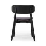 A fresh, exaggerated take on the wing-back dining chair. Finished a classic jet black, a mix of solid ash and ash veneer makes a modern and shapely seating statement with midcentury undertones. Complemented by a cushioned seat in black top-grain leather exclusive to Four Hands. Amethyst Home provides interior design, new construction, custom furniture, and area rugs in the Austin metro area.