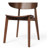 A fresh, exaggerated take on the wing-back dining chair. Finished in a natural hue, a mix of solid ash and ash veneer makes a modern and shapely seating statement with mid-century undertones. Amethyst Home provides interior design, new construction, custom furniture, and area rugs in the Seattle metro area.