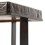 A cradle, angular base of black-finished iron supports a squared tabletop of hand-cast recycled glass in a smoky amber. Perfectly sized to keep your favorite drink or book within reach. Amethyst Home provides interior design, new construction, custom furniture, and area rugs in the Park City metro area.
