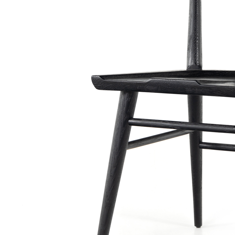 Finished in a beautifully classic black oak, the Gregory Black Oak Dining Chair features a yoke-like back and widened supports, placing a fresh twist on the traditional Windsor. Amethyst Home provides interior design, new construction, custom furniture, and rugs for the Atlanta metro area.