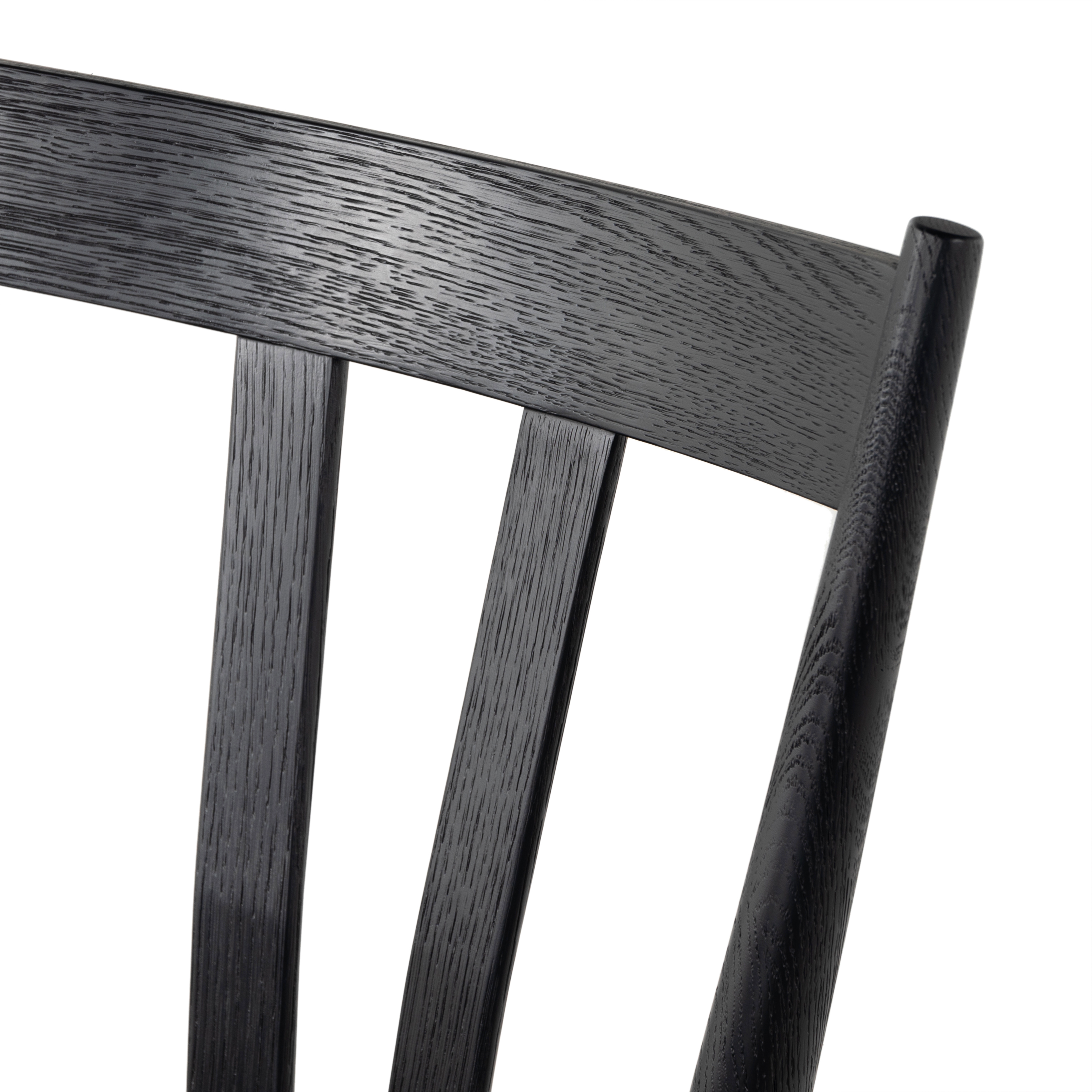 Finished in a beautifully classic black oak, the Gregory Black Oak Dining Chair features a yoke-like back and widened supports, placing a fresh twist on the traditional Windsor. Amethyst Home provides interior design, new construction, custom furniture, and rugs for the Charlotte, North Carolina metro area.