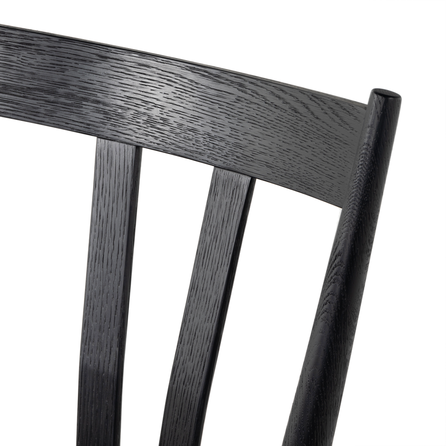 Finished in a beautifully classic black oak, the Gregory Black Oak Dining Chair features a yoke-like back and widened supports, placing a fresh twist on the traditional Windsor. Amethyst Home provides interior design, new construction, custom furniture, and rugs for the Charlotte, North Carolina metro area.