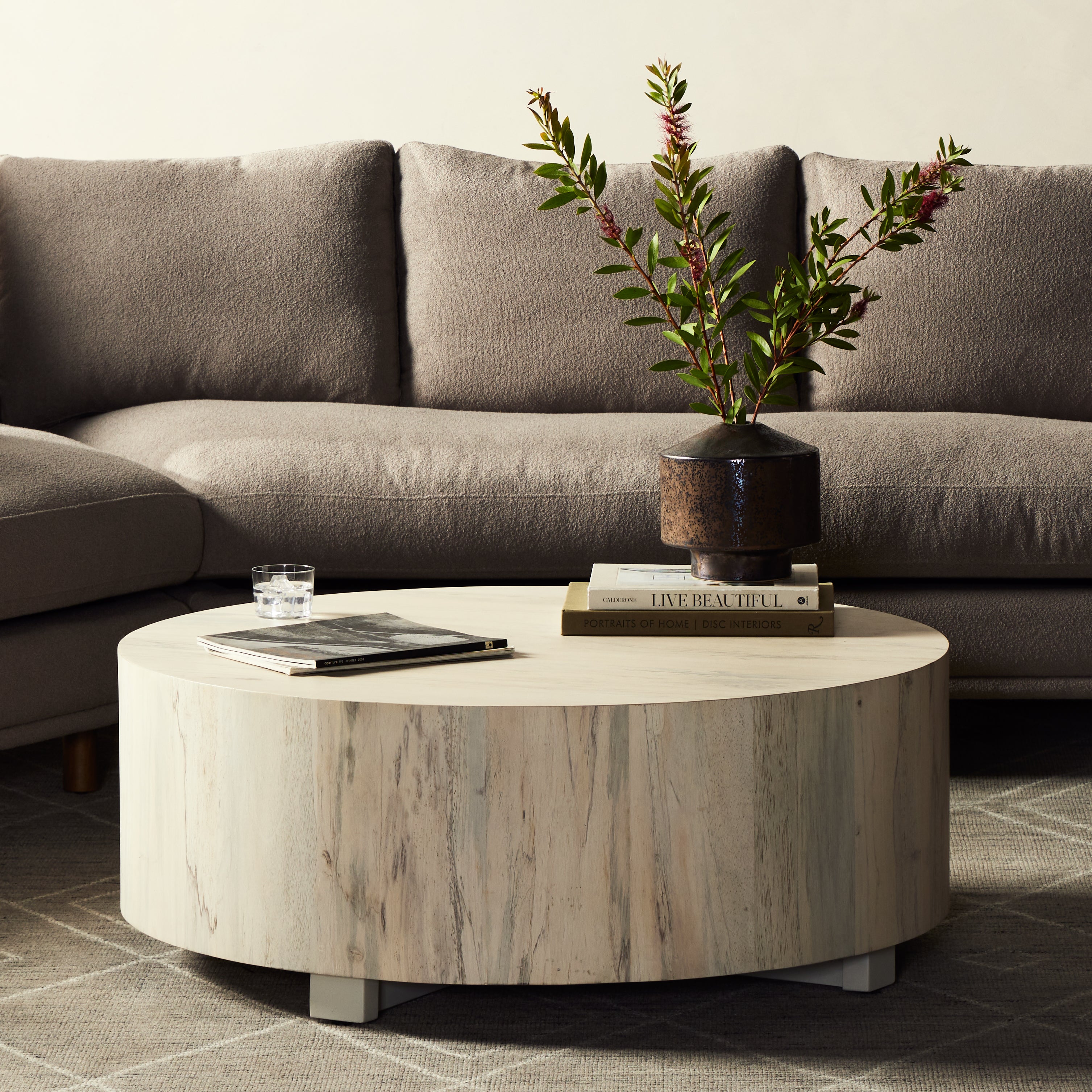 Stunning forces of nature are captured in a coffee table, as spalted primavera wood is hand-shaped into a cylindrical silhouette and finished in a white hue. Reflective of woods' natural character, a slight color variance is possible. Amethyst Home provides interior design, new construction, custom furniture, and area rugs in the Omaha metro area.