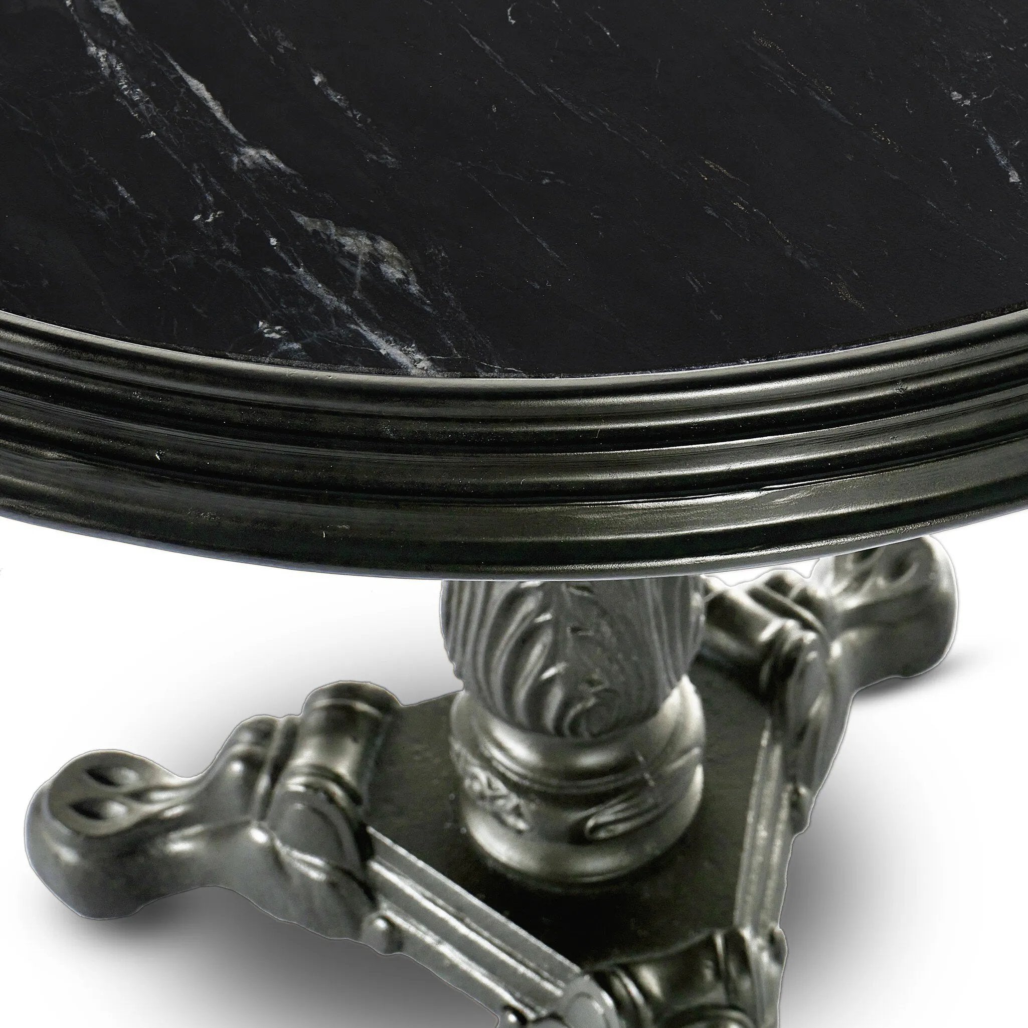 For a fresh take on classic Parisian styling, an ornate cast iron base is topped with black marble.Collection: Rockwel Amethyst Home provides interior design, new home construction design consulting, vintage area rugs, and lighting in the Los Angeles metro area.