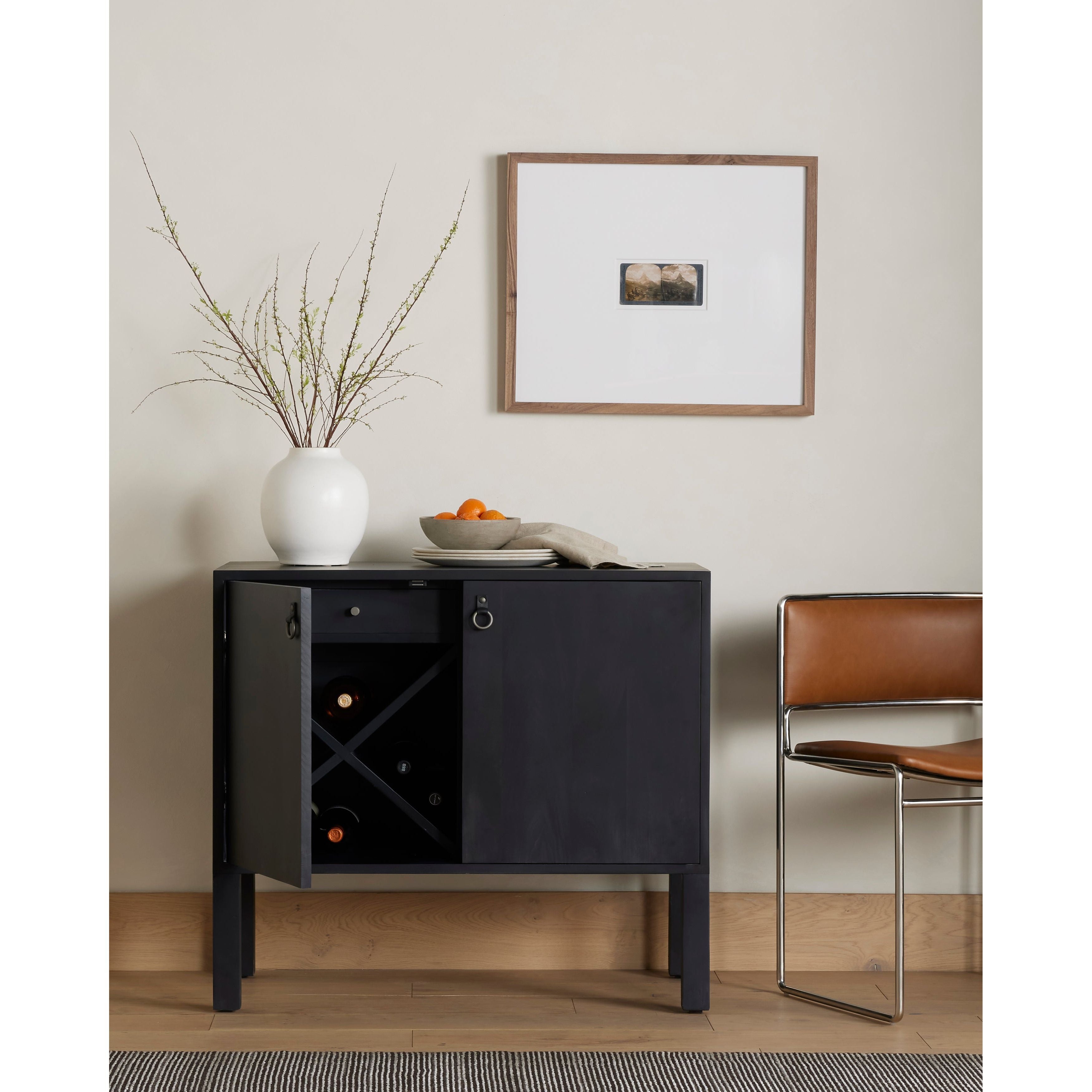 Featuring Isador Black Wash Poplar Bar Cabinet by Four Hands at Amethyst Home. Beautifully simple in spirit. Black-washed solid poplar forms a Parsons-style bar cabinet, with iron and leather hardware for a material-driven update to Shaker-inspired styling. Inside, dual drawers plus generous bottle storage await drink go-tos and bar accessories.Overall Dimensions: 36"W x 19"L x . Amethyst Home provides interior design, new construction, custom furniture, and area rugs in the Alpharetta metro area.