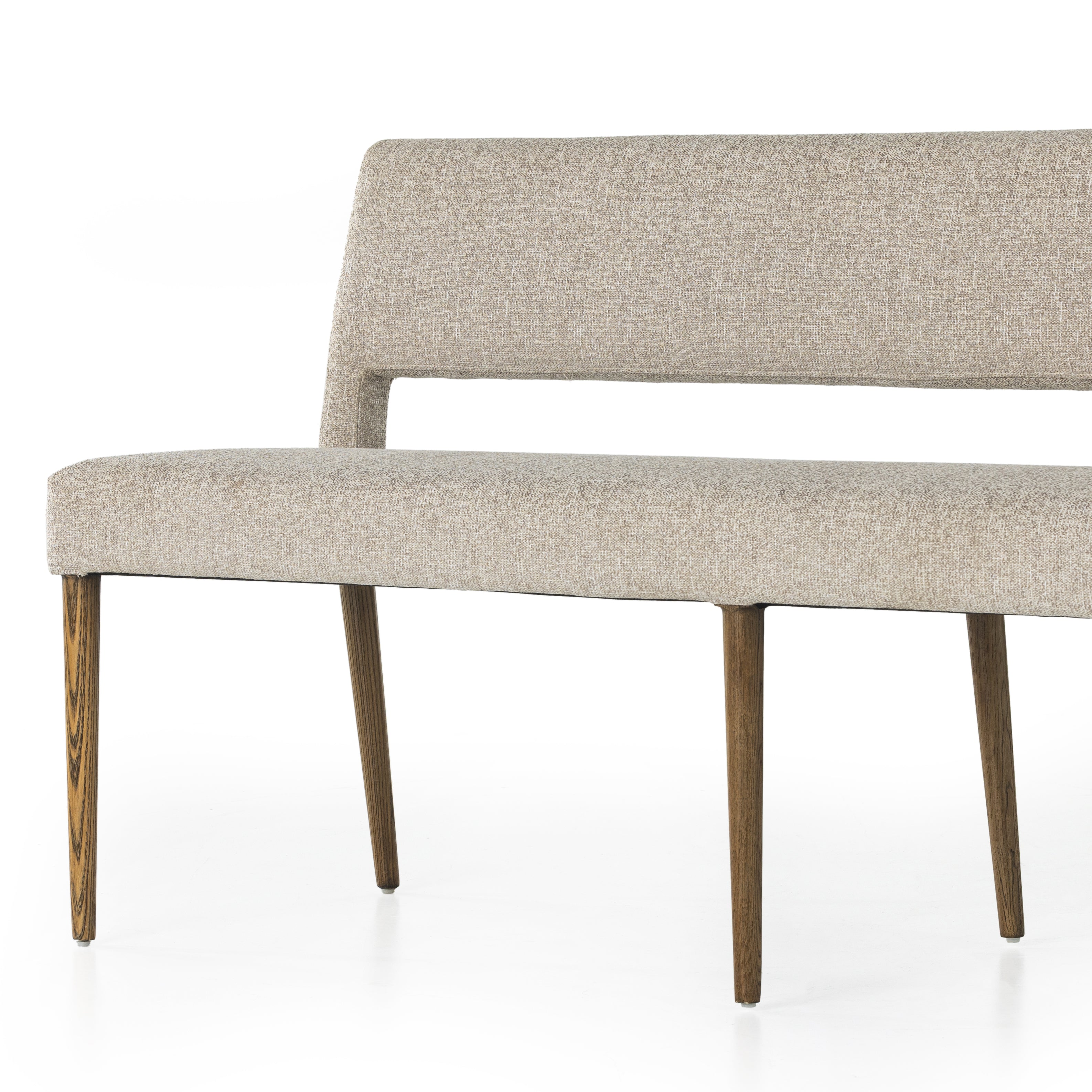 Simply styled and midcentury-minded, Joseph Light Camel Dining Bench is a textural light taupe upholstery that features a posterior cutout for added flair, with toasted nettlewood legs for natural contrast. Amethyst Home provides interior design services, furniture, rugs, and lighting in the Dallas metro area. 