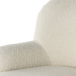 Kadon Natural Swivel Chair is a high wing back pairs with softly rolled arms for a curvy look and supportive sit. Cream-colored shearling-upholstered seating tops a 360-degree swivel. Amethyst Home provides interior design services, furniture, rugs, and lighting in the Dallas metro area.