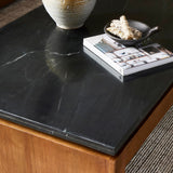 Mixed materials update this waterfall-style coffee table, as a warm oak base pairs with a sleek black marble tabletop. Amethyst Home provides interior design, new construction, custom furniture, and area rugs in the Washington metro area.
