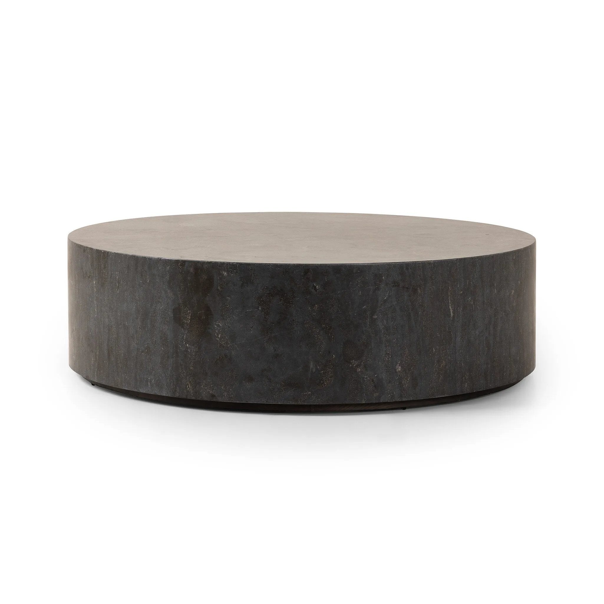 A cylinder-shaped coffee tables brings a shapely look to the living room. Made from natural polished bluestone for an organic look and feel.Collection: Hughe Amethyst Home provides interior design, new home construction design consulting, vintage area rugs, and lighting in the Miami metro area.