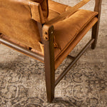 This material-driven take on safari styling features cognac-hued Italian-designed leather that's been lightly sanded and buffed by hand for a suede-like feel. With a tufted sling-style seat, strap arm and pivot back, this vintage-feeling accent chair makes a chic statement wherever it's styled. Amethyst Home provides interior design, new construction, custom furniture, and area rugs in the San Diego metro area.