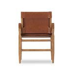 Inspired by a vintage safari-style frame, this dining chair is defined by the fluid strap arms. Semi-attached cushions in rich chestnut leather, finished with button tufting details. Parawood frame and brass details add warmth and texture.Collection: Westgat Amethyst Home provides interior design, new home construction design consulting, vintage area rugs, and lighting in the Boston metro area.