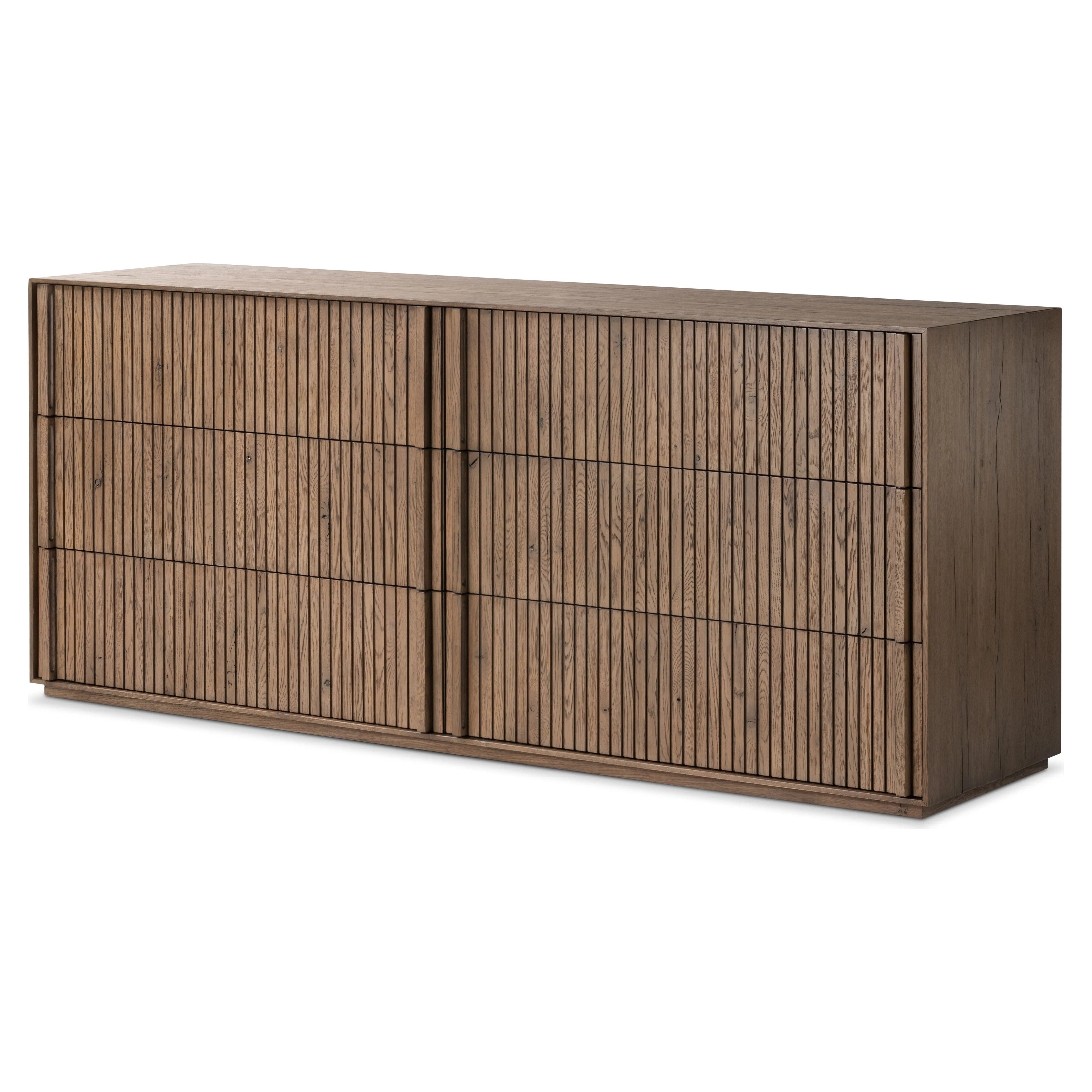 Designed by Thomas Bina and Ronald Sasson, a design partnership blending both modern minimalist and Brazilian influences. Crafted from solid oak, this clean-lined dresser features vertical reed detailing on the drawer fronts with wooden pull detailing on the outer edges. Drawers are finished with soft close under-mount drawer glides.Collection: Bin Amethyst Home provides interior design, new home construction design consulting, vintage area rugs, and lighting in the Alpharetta metro area.