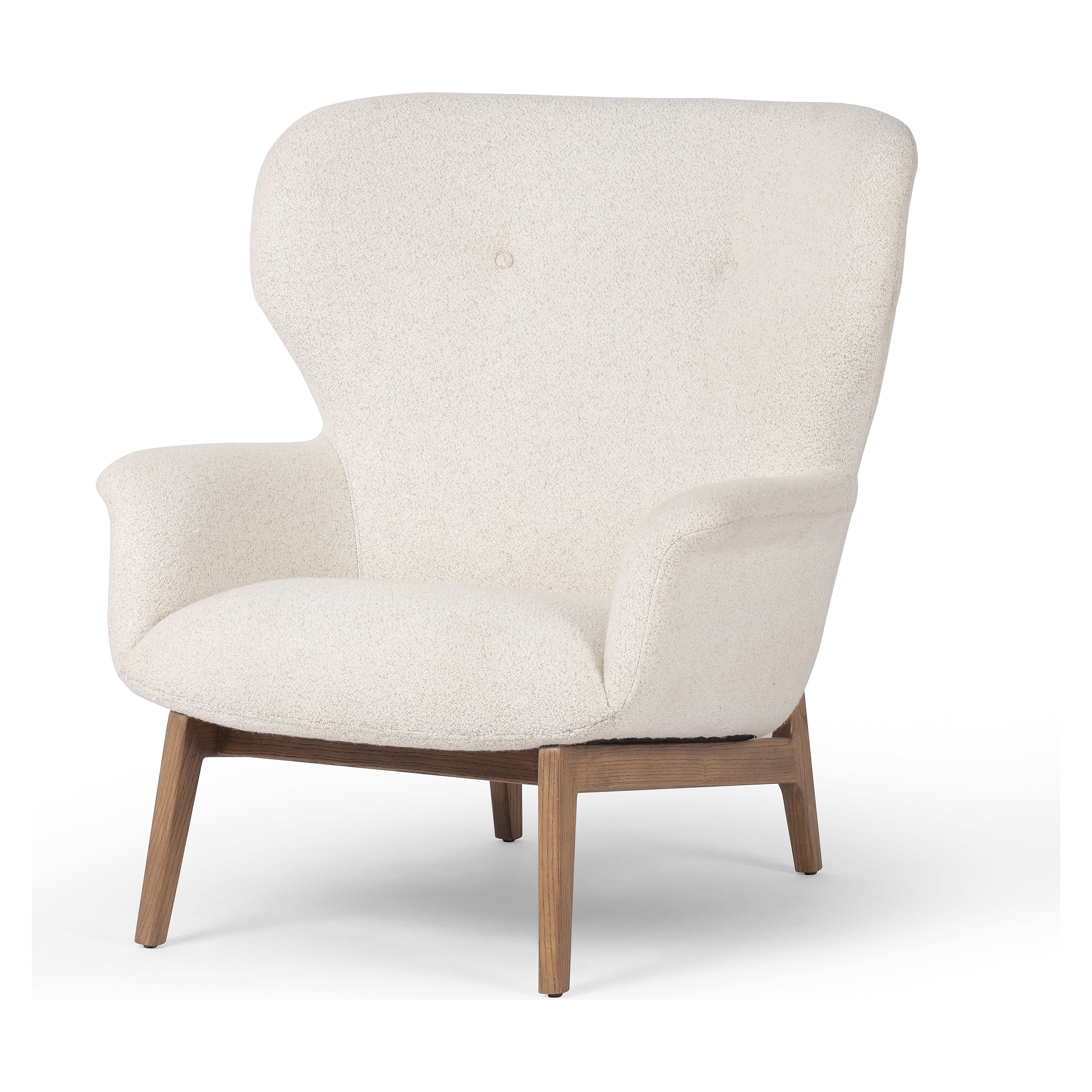 The classic wingback chair is updated with a midcentury-style base. Flared arms and a high winged back with blind tufting offer all-around comfort. Upholstered in a heavily textured boucle performance fabric bringing movement and everyday function to the piece. Amethyst Home provides interior design, new construction, custom furniture, and area rugs in the Laguna Beach metro area.