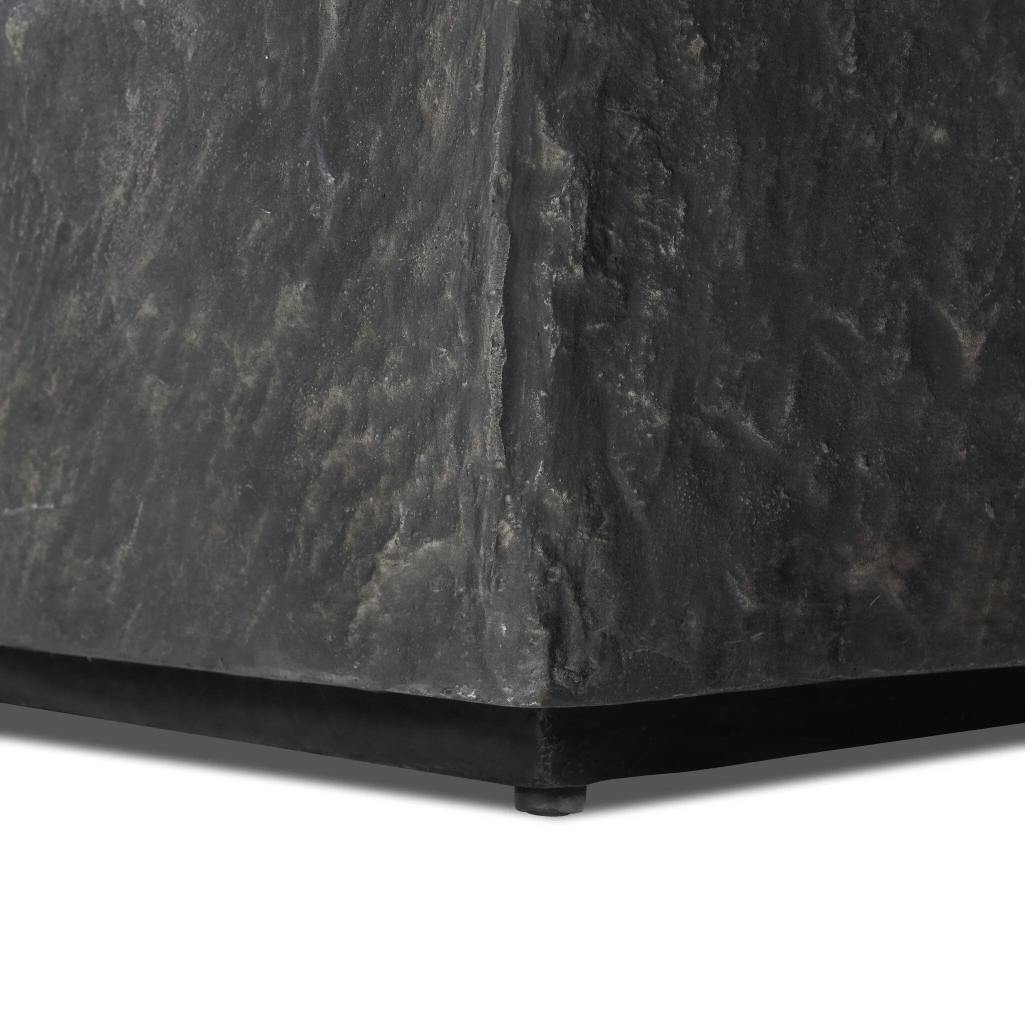 Cast black concrete features heavily textured sides that resemble natural slate, paired with a smoothed tabletop.Collection: Chandle Amethyst Home provides interior design, new home construction design consulting, vintage area rugs, and lighting in the San Diego metro area.