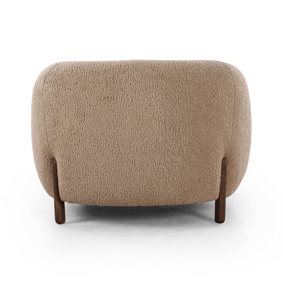 Lyla Sheepskin Camel Chair is a fresh take on the traditional tub chair, with exaggerated depth for drama and comfort. Solid wood legs intersect sheepskin upholstery for clean contrast and scale. Amethyst Home provides interior design services, furniture, rugs, and lighting in the Kansas City metro area.