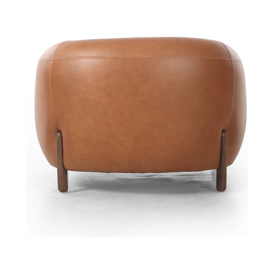 This updated take on the traditional tub chair pairs rich, camel-colored top-grain leather with solid ash to shape a sculpted seat with exaggerated depth. Amethyst Home provides interior design, new construction, custom furniture, and area rugs in the Boston metro area.
