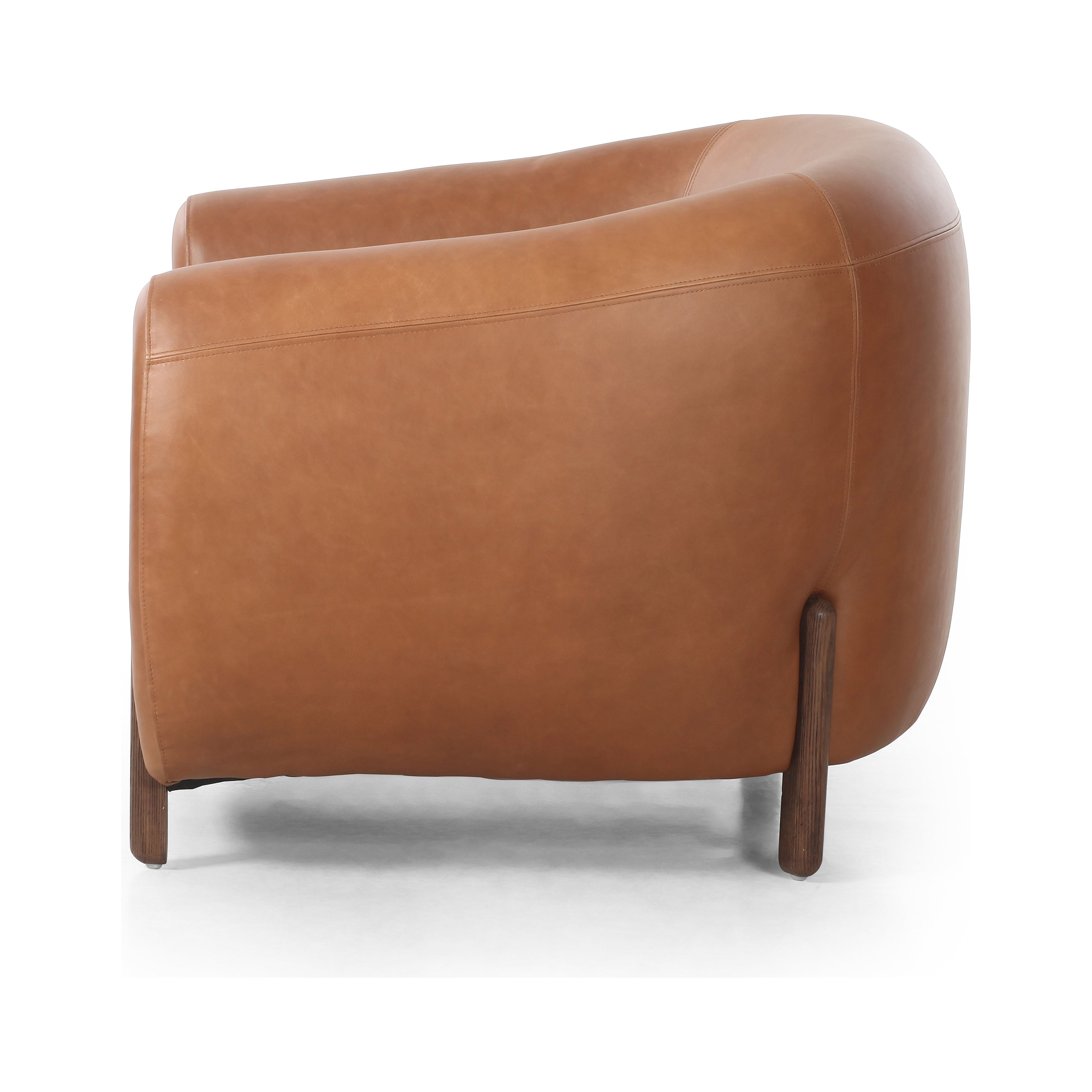 This updated take on the traditional tub chair pairs rich, camel-colored top-grain leather with solid ash to shape a sculpted seat with exaggerated depth. Amethyst Home provides interior design, new construction, custom furniture, and area rugs in the Park City metro area.