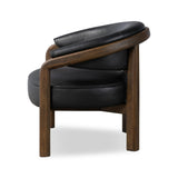This floating wrap chair features an exposed wood profile that cradles seat and back cushions, all upholstered in black top-grain leather. The frame feels fluid, as it travels from the ground to the upholstered back rest and back down through the hind legs. Spring suspension ensures stylish comfort.Collection: Farro Amethyst Home provides interior design, new home construction design consulting, vintage area rugs, and lighting in the Nashville metro area.