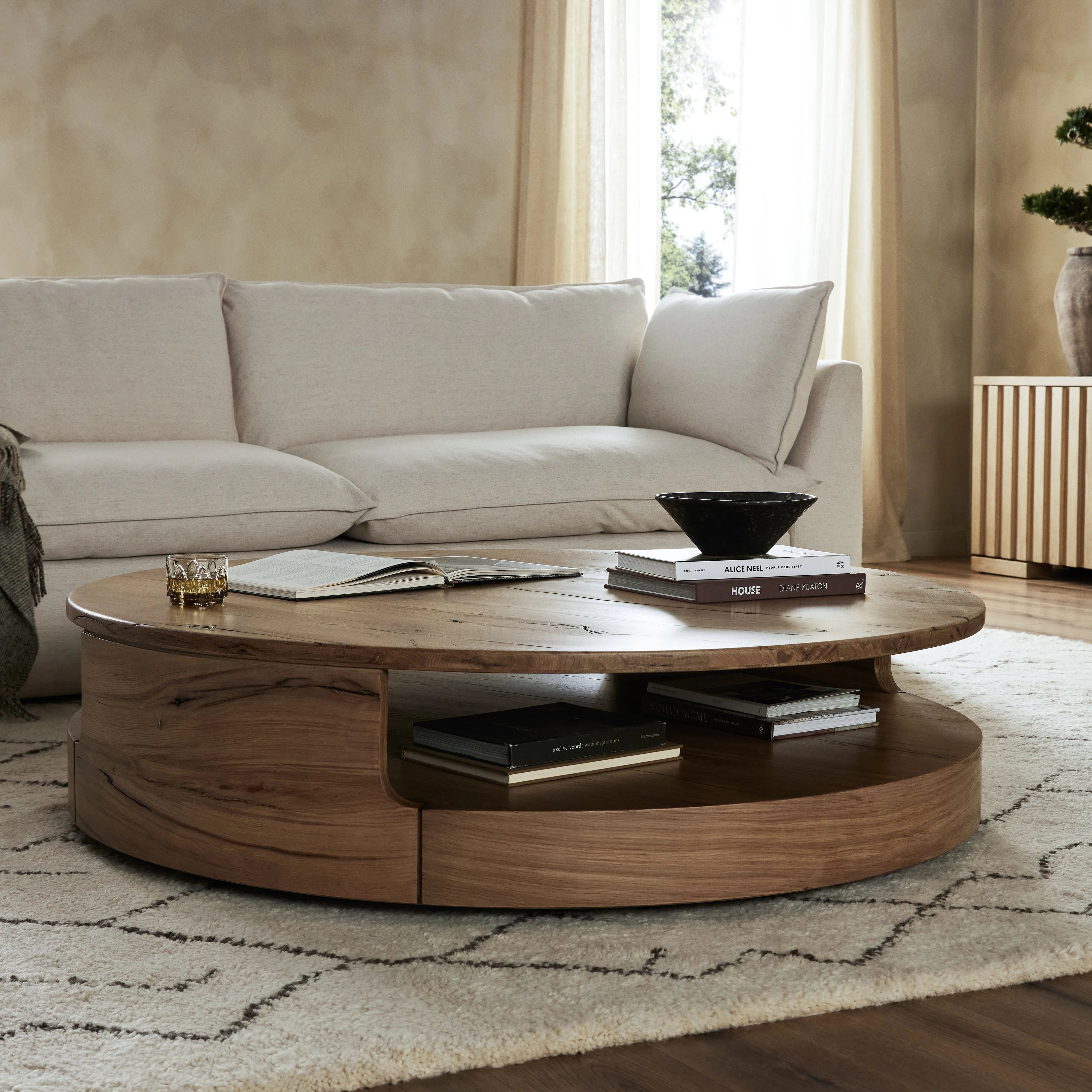 Designed in partnership with longtime Four Hands collaborator Thomas Bina and Brazilian designer Ronald Sasson. A rounded coffee table made from reclaimed French oak, features beautiful natural graining. Lower layer lightens the whole look, while brining the option for bonus storage or display.Collection: Bin Amethyst Home provides interior design, new home construction design consulting, vintage area rugs, and lighting in the Winter Garden metro area.