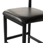 Monochromatic meets midcentury with this bar-height stool. Structured while comfortable, the tapered-leg chair pairs an ebony wood frame with a faux leather cushion.Collection: Ashfor Amethyst Home provides interior design, new home construction design consulting, vintage area rugs, and lighting in the Los Angeles metro area.