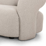 A fluid play on seating. This statement making sofa features subtle cutouts on the back with plush arms that hug the bench seat. Upholstered in a tight, wool-like textile for a polished look.Collection: Grayso Amethyst Home provides interior design, new home construction design consulting, vintage area rugs, and lighting in the Tampa metro area.