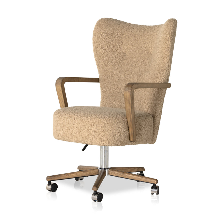 A comfort-driven desk chair features soft, textural upholstery in a versatile camel, framed by solid ash arms. A height-adjustable swivel base with casters makes for ease in the modern office. Amethyst Home provides interior design, new home construction design consulting, vintage area rugs, and lighting in the Boston metro area.