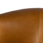 Supple, camel-colored top-grain leather hugs the curves of this modern-shaped seat, featuring a hidden 360-degree swivel. Amethyst Home provides interior design, new construction, custom furniture, and area rugs in the Austin metro area.