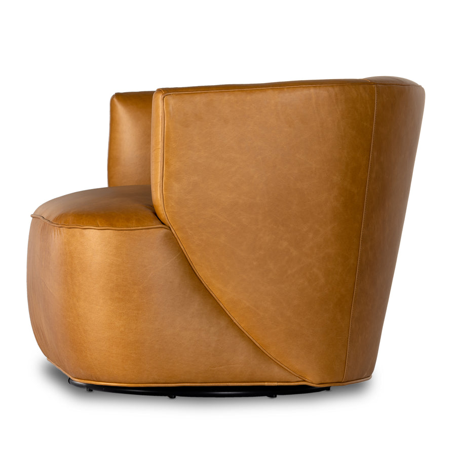 Supple, camel-colored top-grain leather hugs the curves of this modern-shaped seat, featuring a hidden 360-degree swivel. Amethyst Home provides interior design, new construction, custom furniture, and area rugs in the Calabasas metro area.