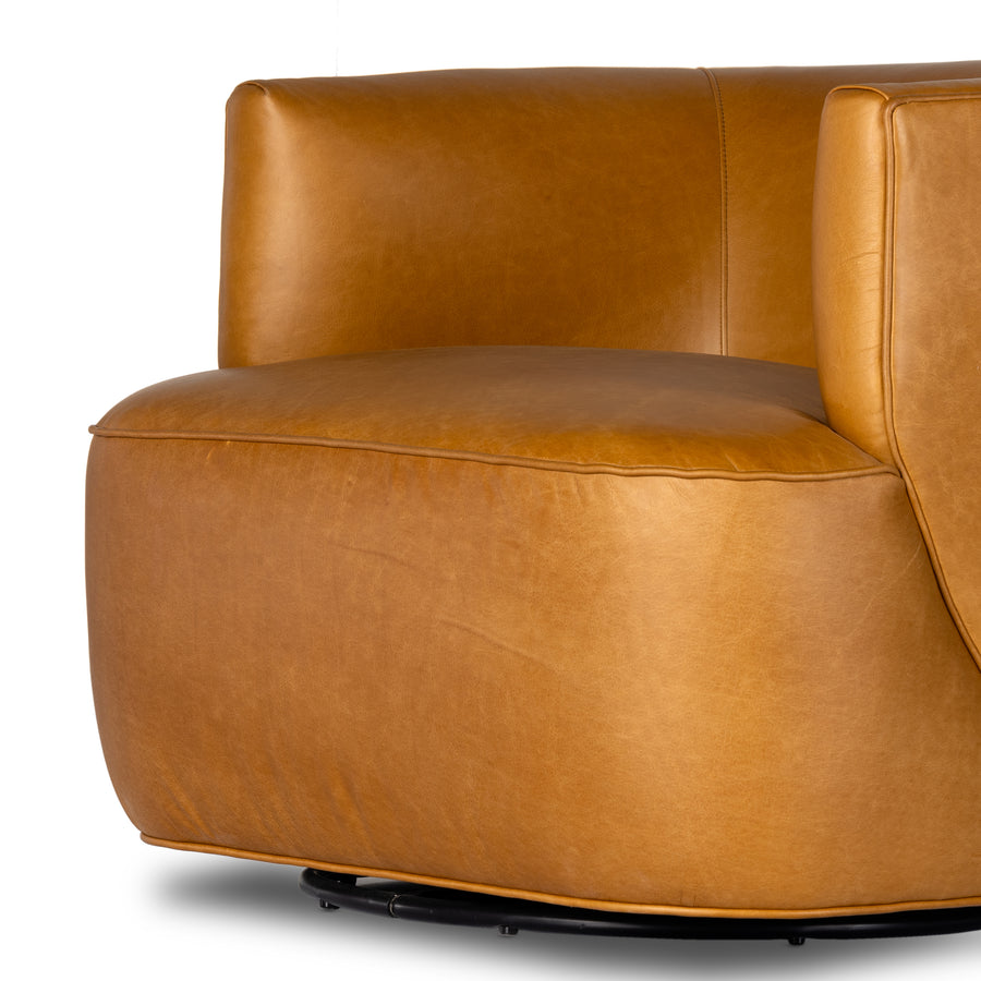 Supple, camel-colored top-grain leather hugs the curves of this modern-shaped seat, featuring a hidden 360-degree swivel. Amethyst Home provides interior design, new construction, custom furniture, and area rugs in the Houston metro area.