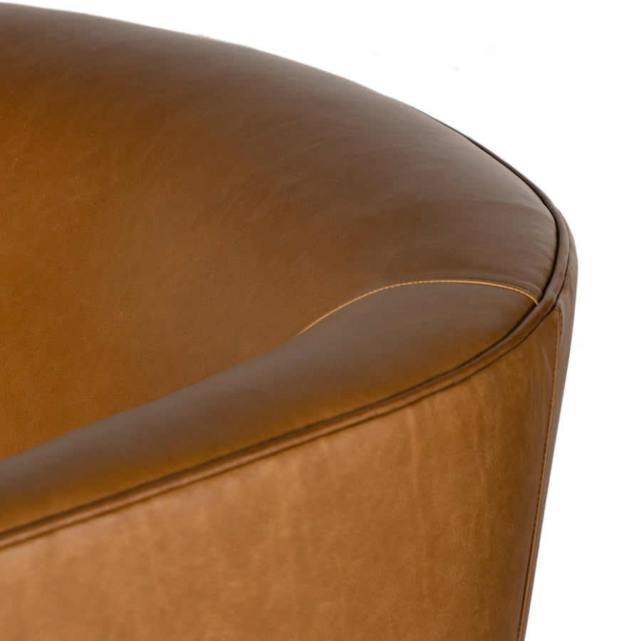 Supple, camel-colored top-grain leather hugs the curves of this modern-shaped seat, featuring a hidden 360-degree swivel. Amethyst Home provides interior design, new construction, custom furniture, and area rugs in the Newport Beach metro area.