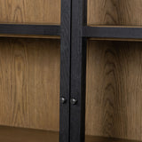 Matte black drifted oak frames lighter interior shelving for subtle but striking contrast. Glass doors allow for prized possessions to dazzle on full display while spacious cabinets add out-of-view storage. Amethyst Home provides interior design, new construction, custom furniture, and area rugs in the San Diego metro area.