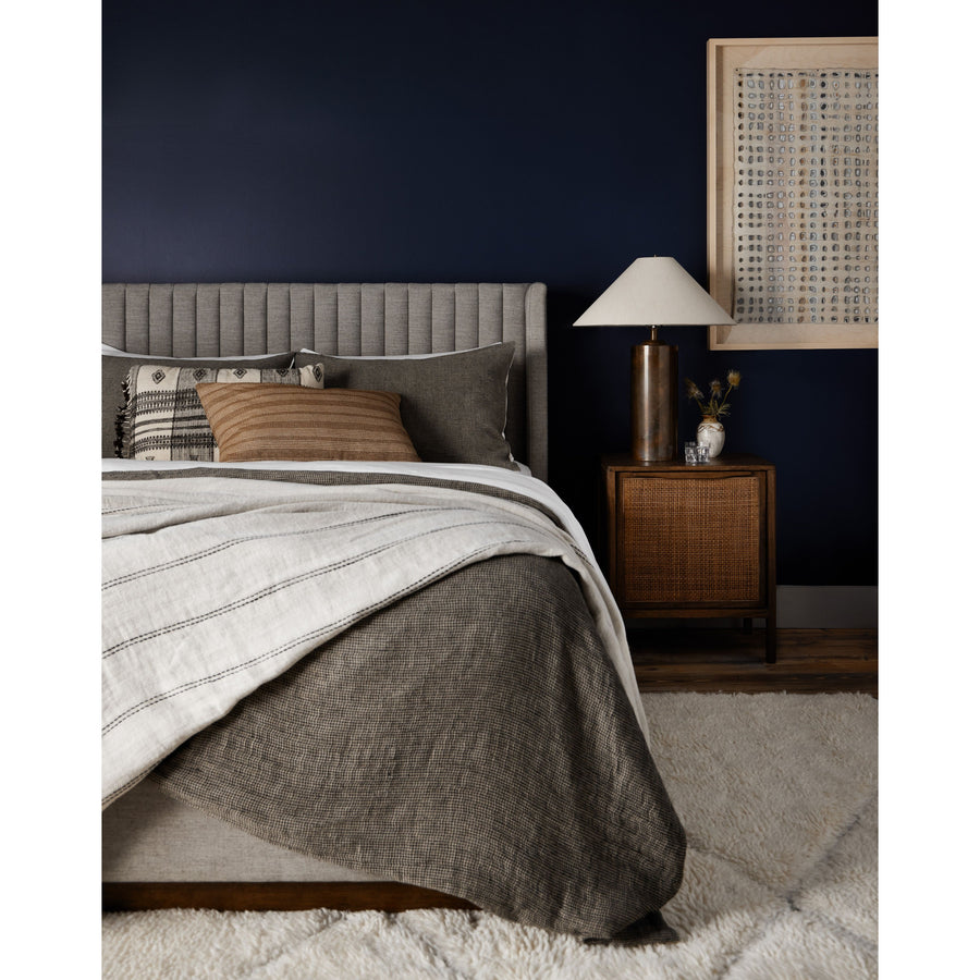 The Montgomery Bed is a tall, vertical-channeled headboard that is upholstered in grey high-performance fabric for a sensible take on modern bedroom styling. Amethyst Home provides interior design services, furniture, rugs, and lighting in the Monterey metro area.