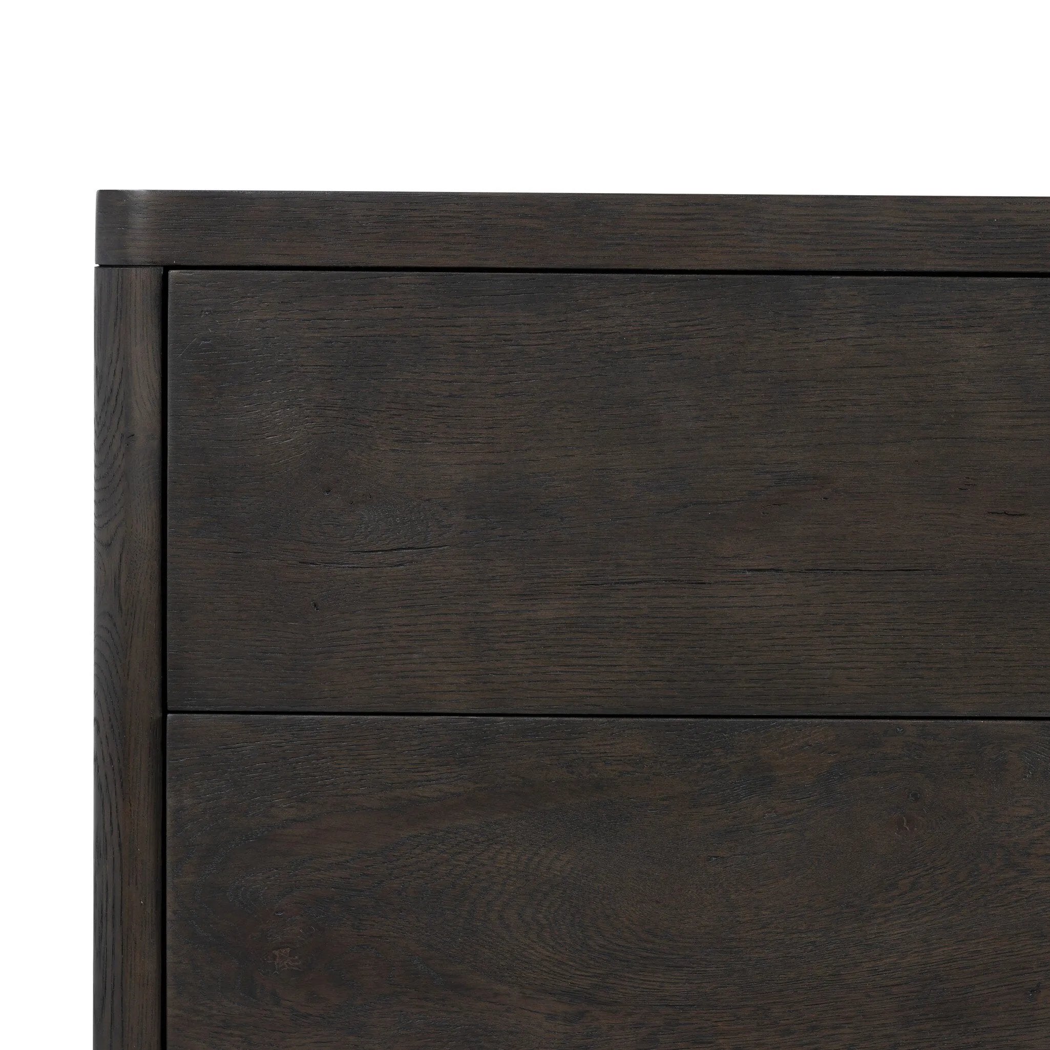 Topped with a thick plank of solid oak, this extra-wide nightstand blends modern lines and warm character with two roomy drawers, slightly curved corners, and solid square legs. Seamless drawer fronts have a push-latch mechanism. Made from solid oak and veneer in a smoky black finish.Collection: Bolto Amethyst Home provides interior design, new home construction design consulting, vintage area rugs, and lighting in the Houston metro area.
