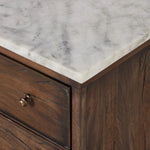 Capturing the charm of vintage French storage, this solid mango wood nightstand stands tall with a polished marble top and softened ogee edges. Three spacious drawers are fitted with classic brass-button hardware. Natural marks and cracks are characteristic of the reclaimed wood.Collection: Harmo Amethyst Home provides interior design, new home construction design consulting, vintage area rugs, and lighting in the Tampa metro area.
