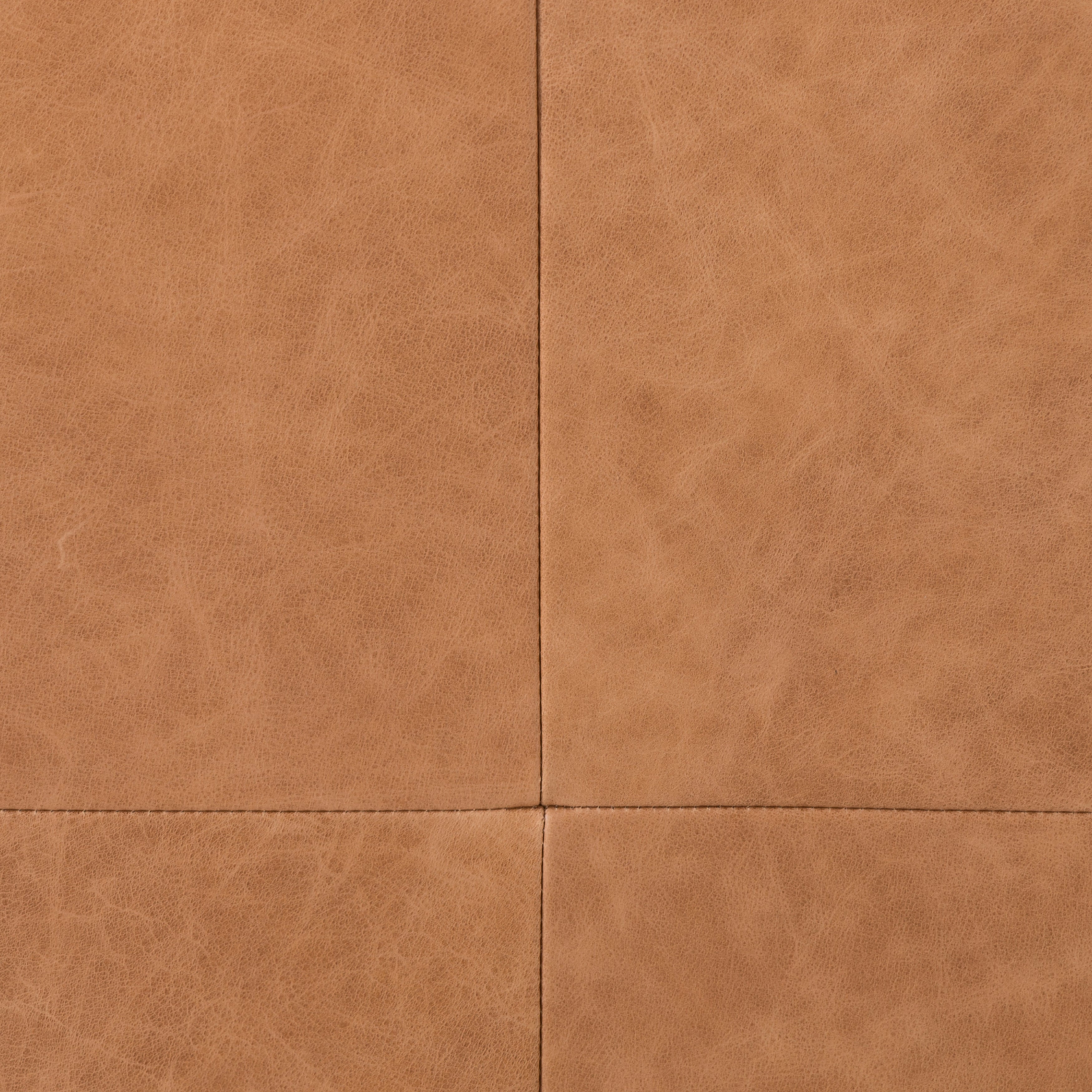 A clean, sophisticated silhouette meets butterscotch top-grain leather with side-arm cutouts, for a balanced look with midcentury vibes. Finished with tapered oak legs. Amethyst Home provides interior design, new construction, custom furniture, and area rugs in the Houston metro area.