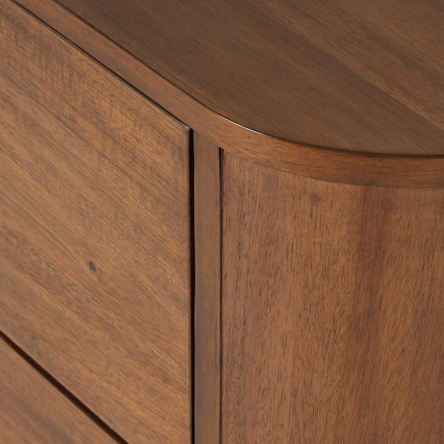 Seasoned brown acacia forms a curved pedestal base, bringing gentle curves to a classic nightstand shape. Amethyst Home provides interior design, new construction, custom furniture, and area rugs in the Tampa metro area.