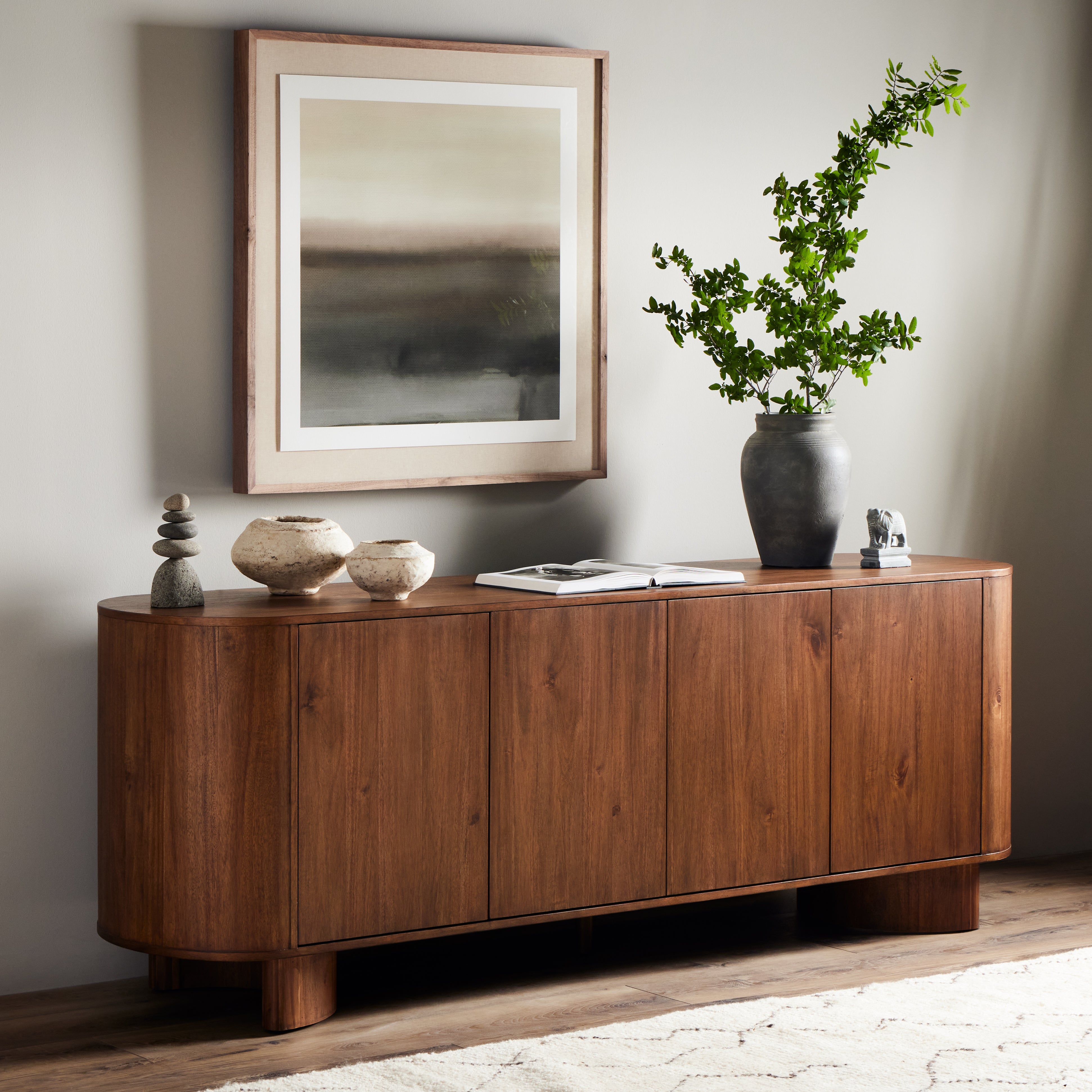 Seasoned brown acacia forms curved legs and the cabinets of this sideboard. Generous space for all dining storage needs. Amethyst Home provides interior design, new construction, custom furniture, and area rugs in the Boston metro area.