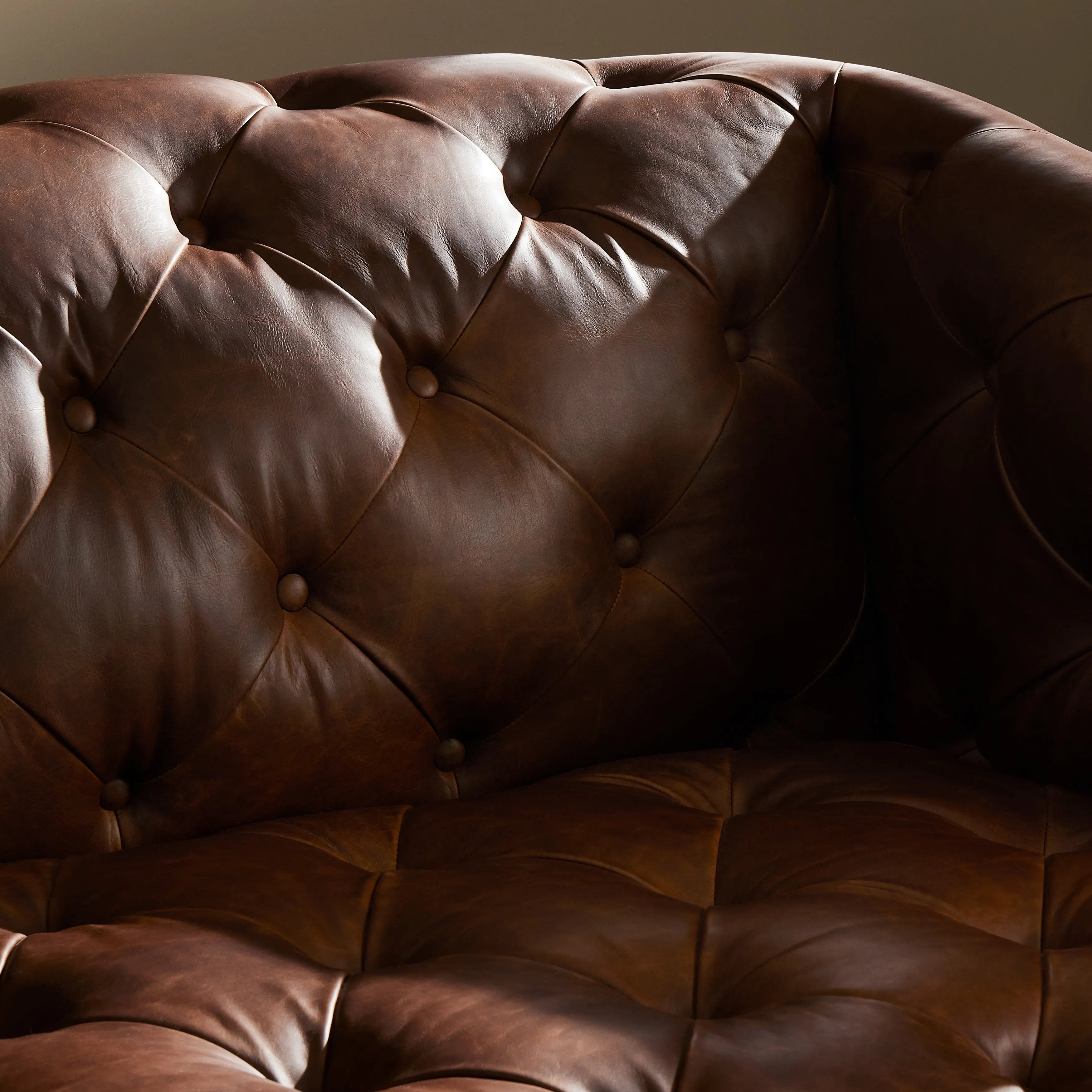 An Old English-inspired design is updated with button tufting across the back and arms. Upholstered in a top-grain leather finished with a soft hand for a vintage, lived-in look on this traditionally inspired sofa. Handcrafted in Italy, the richness of this distinctive, full-bodied leather develops an even-richer patina over time. Amethyst Home provides interior design, new home construction design consulting, vintage area rugs, and lighting in the Salt Lake City metro area.